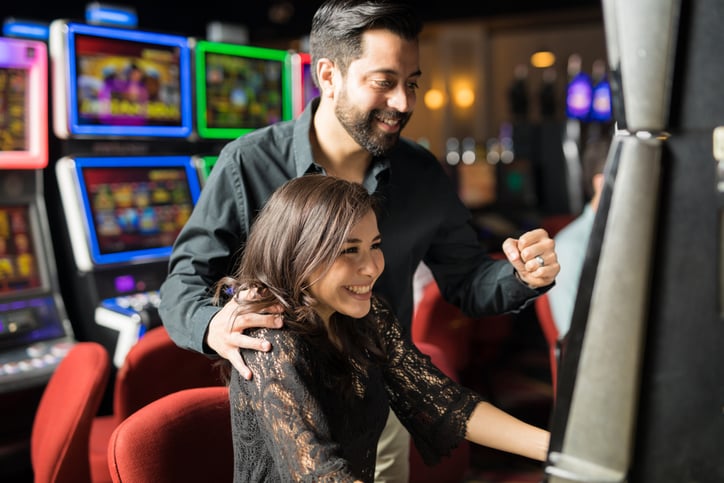 Couple excited over winning on a slot machine