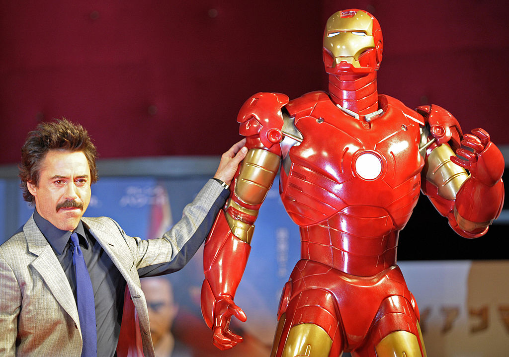 Robert Downey Jr. posing next to Iron Man |  Kitamura/AFP/Getty Images