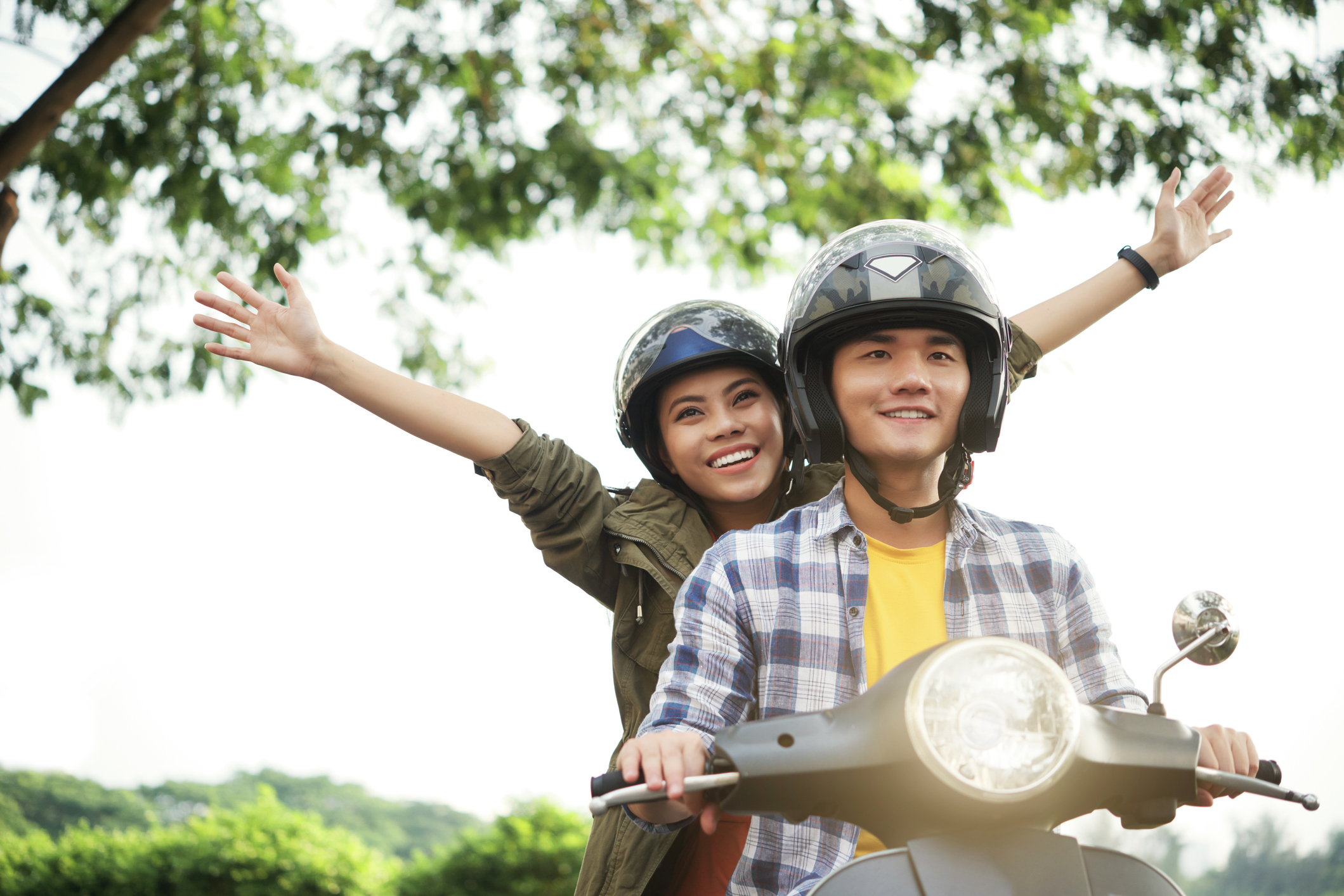 Couple riding a vespa