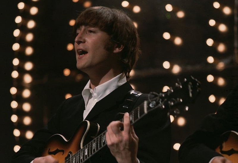 John Lennon performing on stage