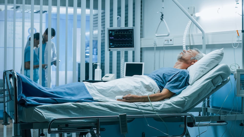 Man laying in a hospital bed after surgery