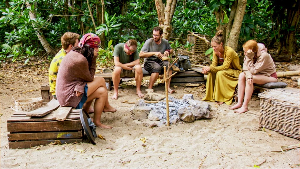 The castaways prepare to share a meal at camp