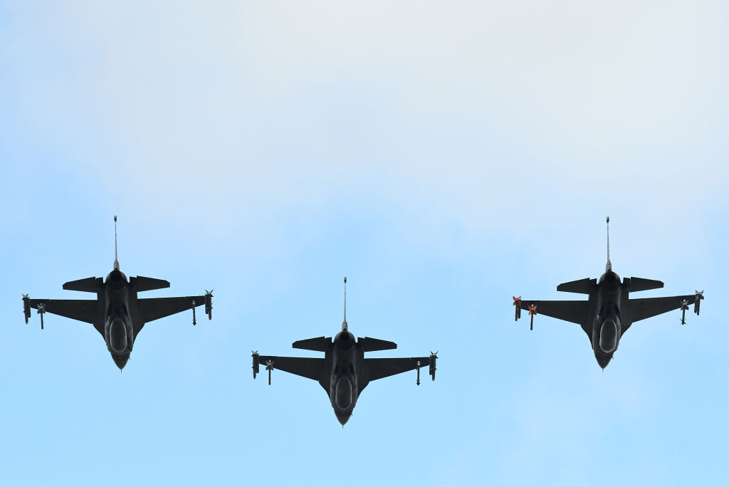 Three fighter jets flying side by side