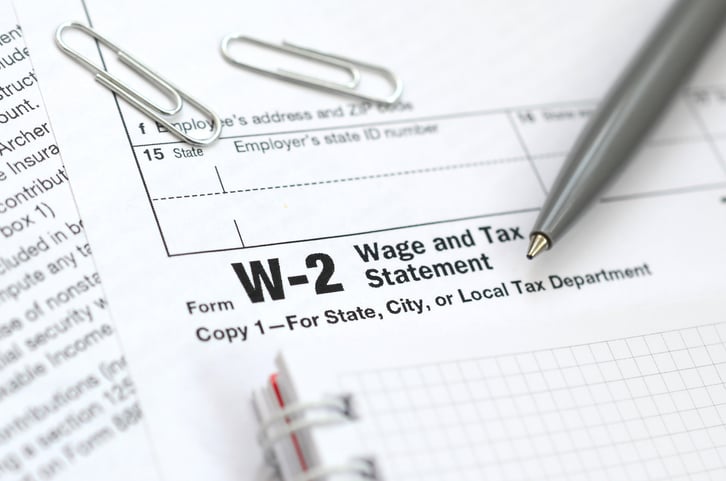 Close up of W-2 form with notebook