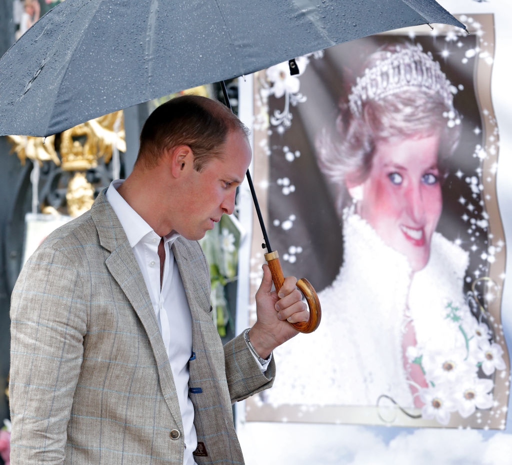 Prince William standing near Princess Diana portrait