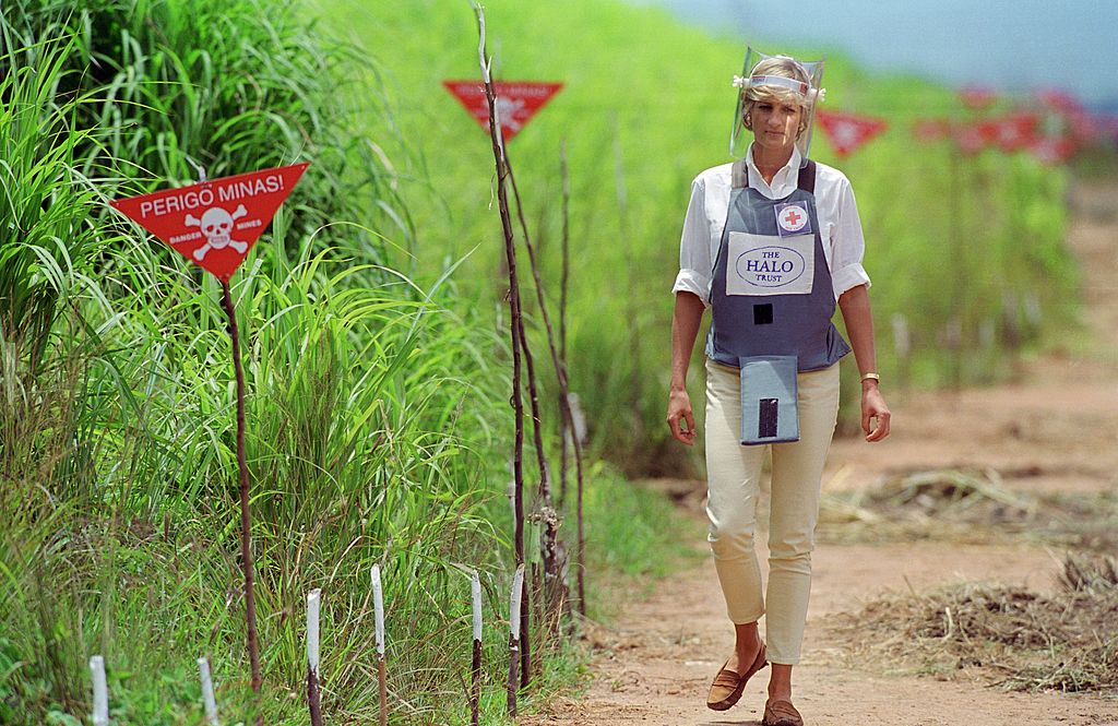 Diana, Princess of Wales wearing protective body armour and a visor visits a landmine minefield being cleared by the charity Halo in Huambo, Angola