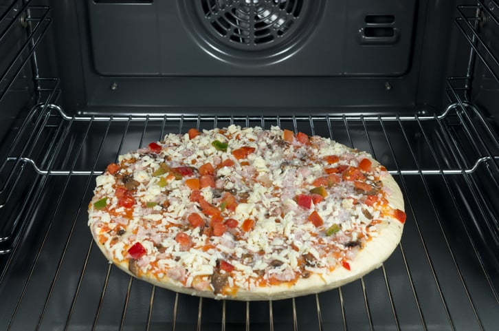 A frozen pizza on an oven rack