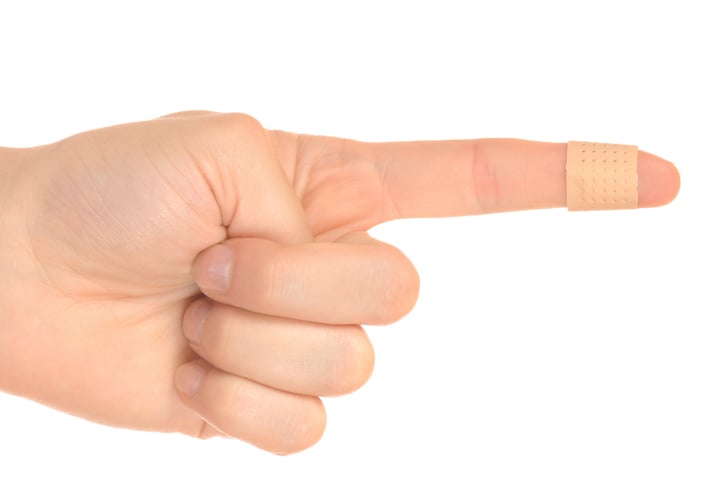 Hand with cut covered by bandaid