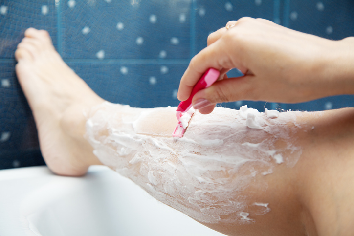 Woman shaving her leg