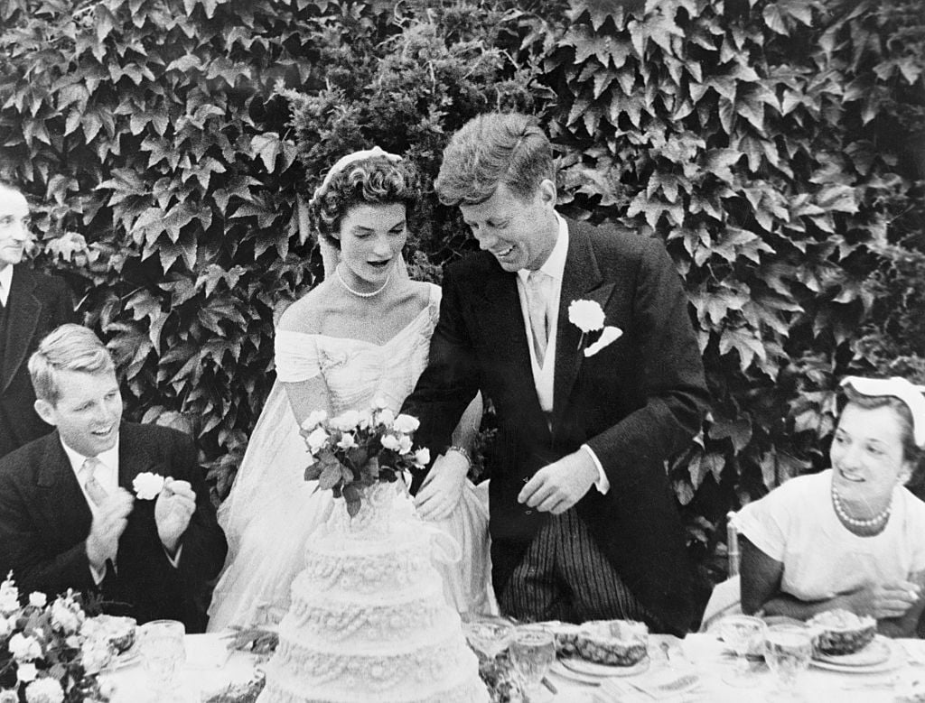 John F. Kennedy and Jacqueline Bouvier cutting their wedding cake after their marriage in Newport, Rhode Island.