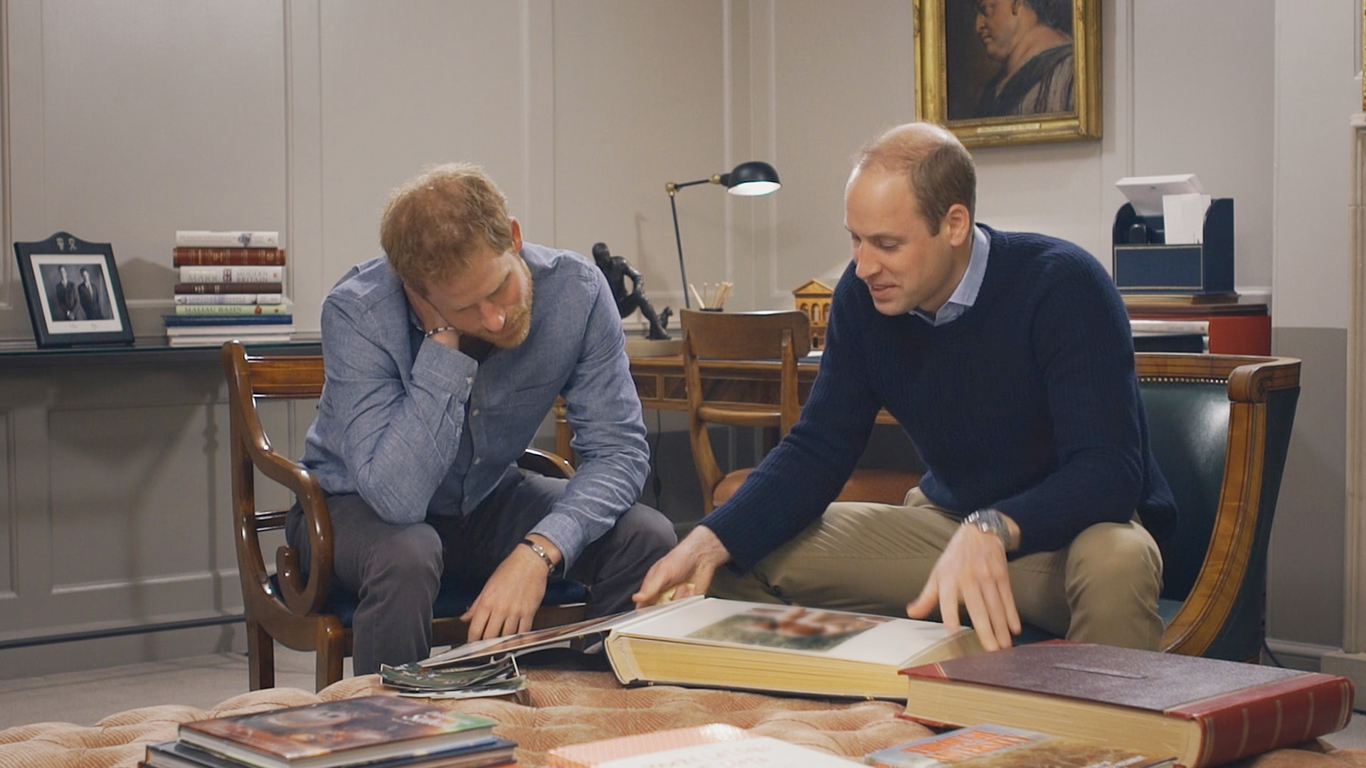 Prince Harry and Prince William look through family photos.