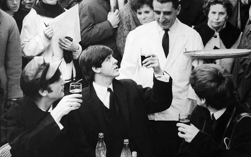 The Beatles have a drink in Paris, 1964.