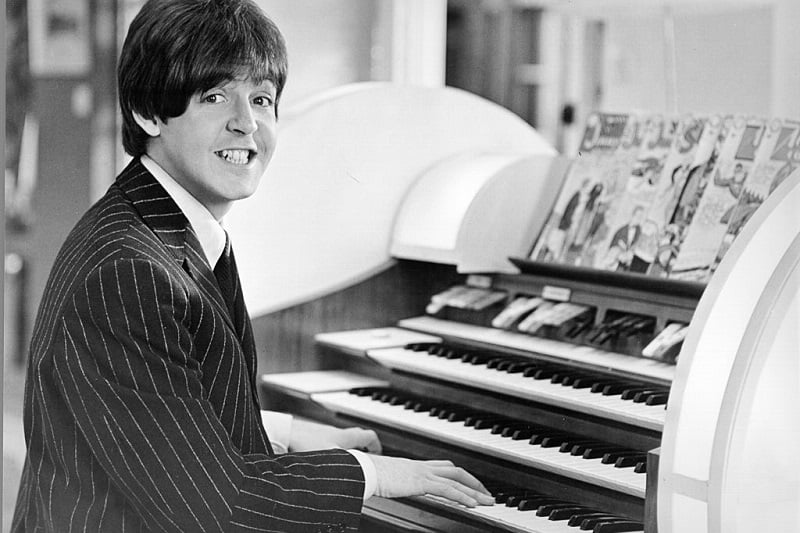 Paul McCartney sitting at organ piano