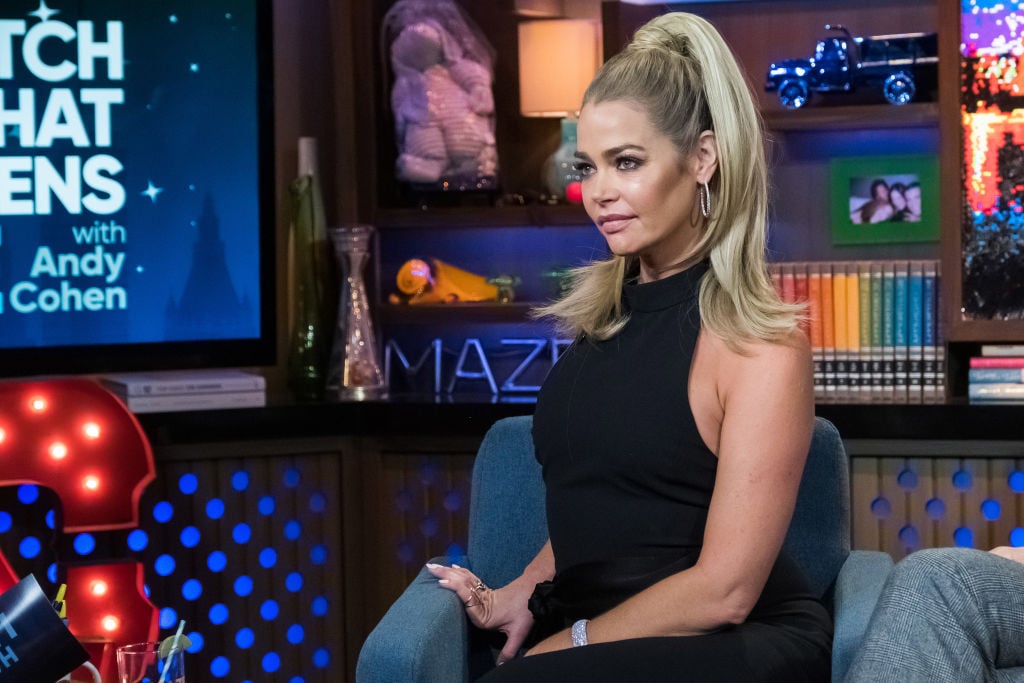 Denise Richards is sitting in a chair on 'Watch What Happens Live'