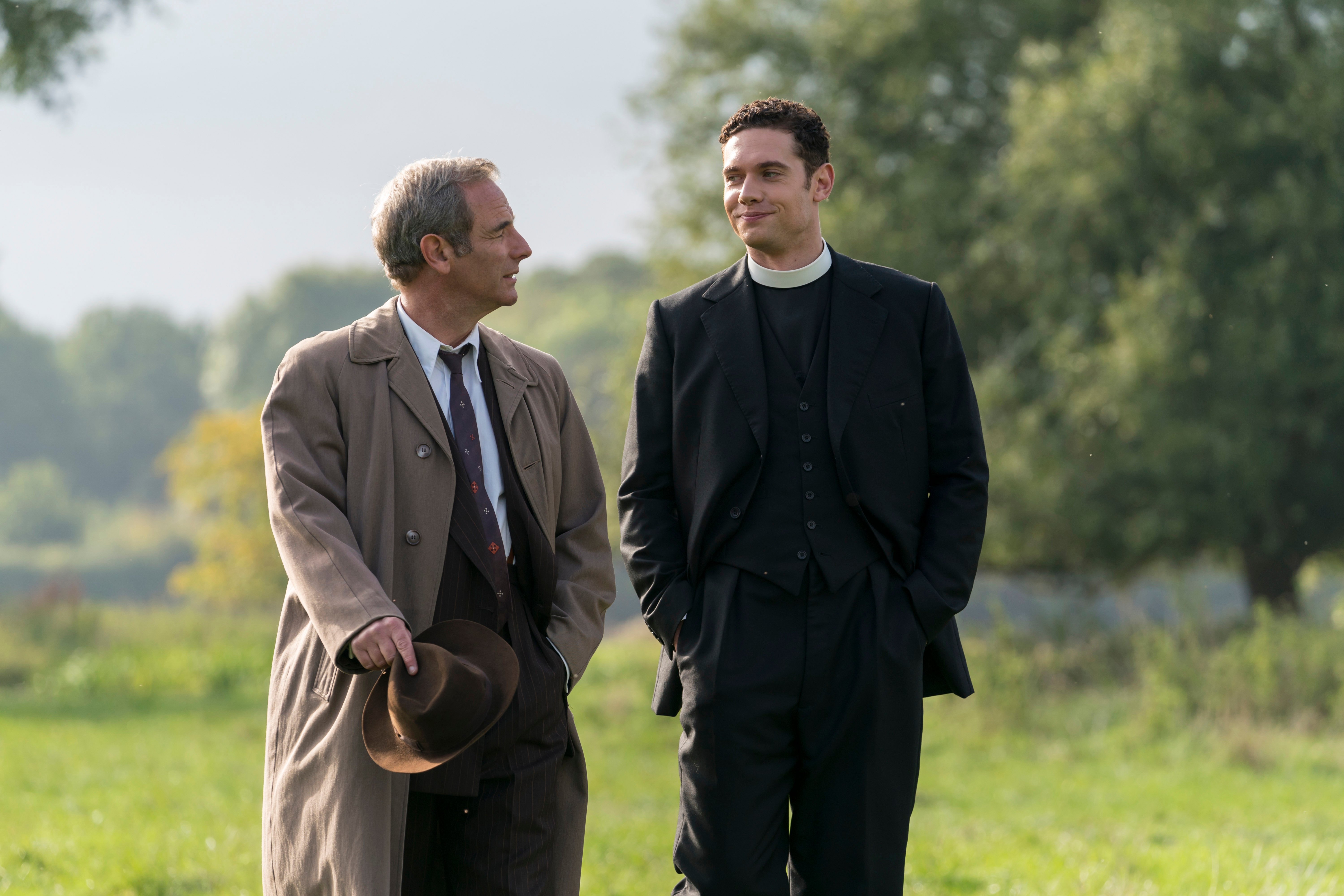 Robson Green and Tom Brittney smiling at each other in episode of 'Grantchester' 