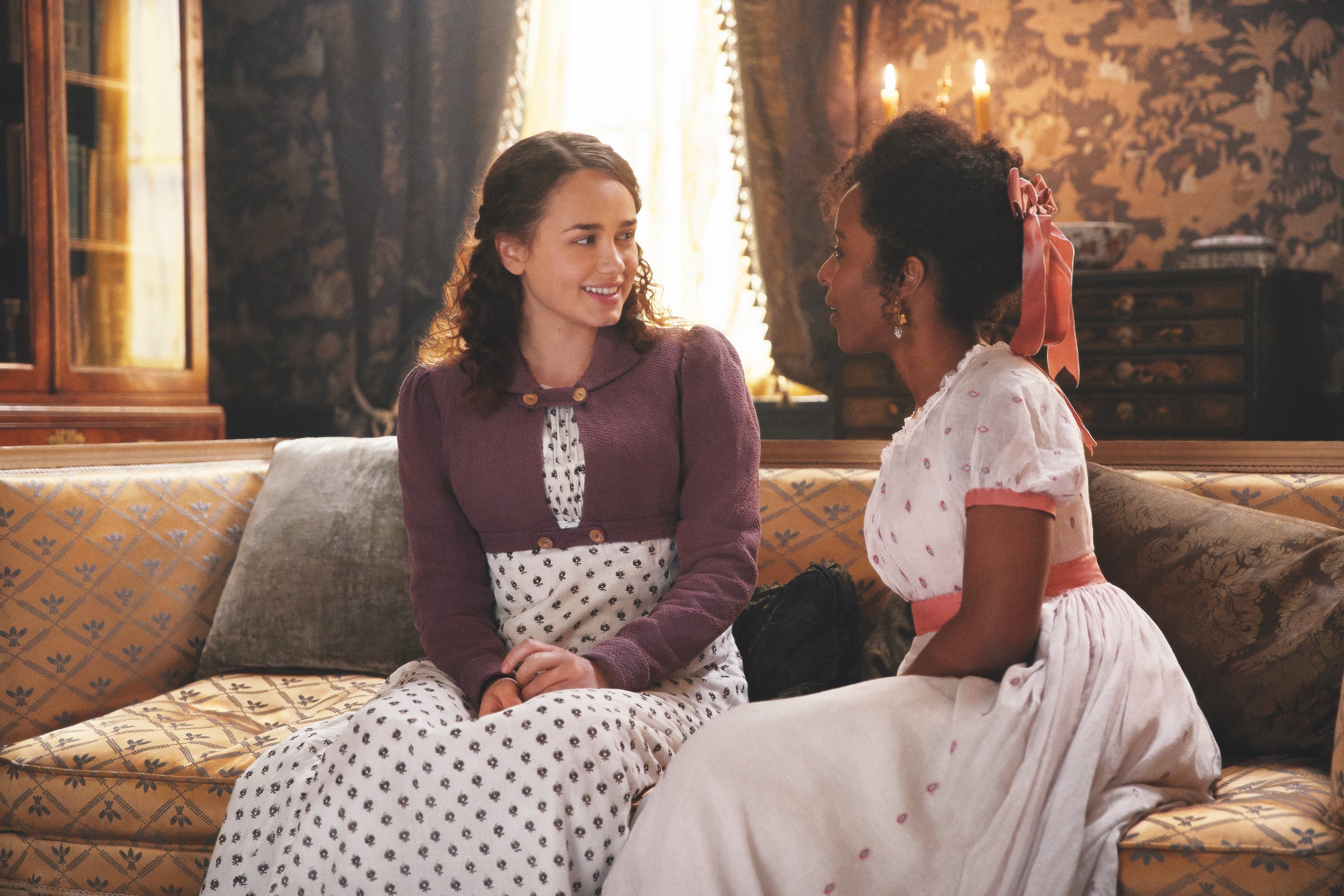Rose Williams and Crystal Clarke sitting on a couch in 'Sanditon' Season 1 