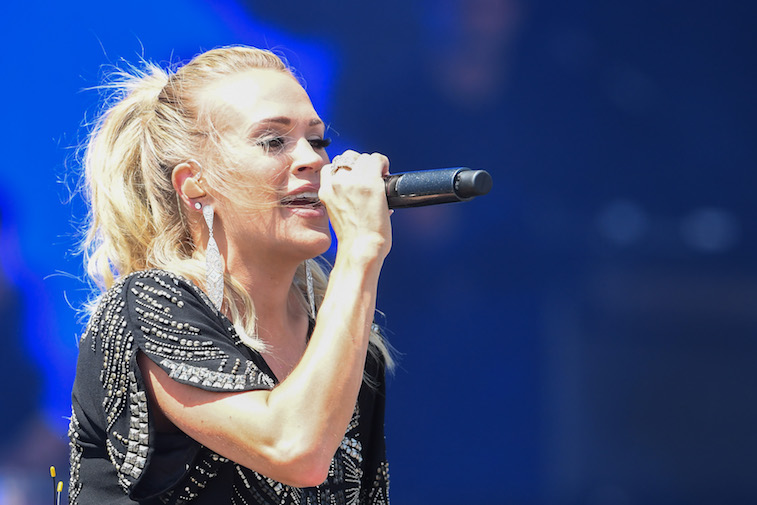 Carrie Underwood performing a song onstage.