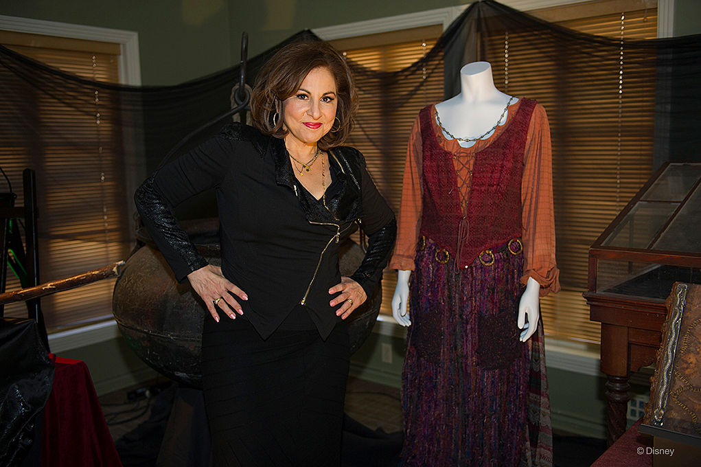 Kathy Najimy stands next to Mary Sanderson costume from 'Hocus Pocus.'