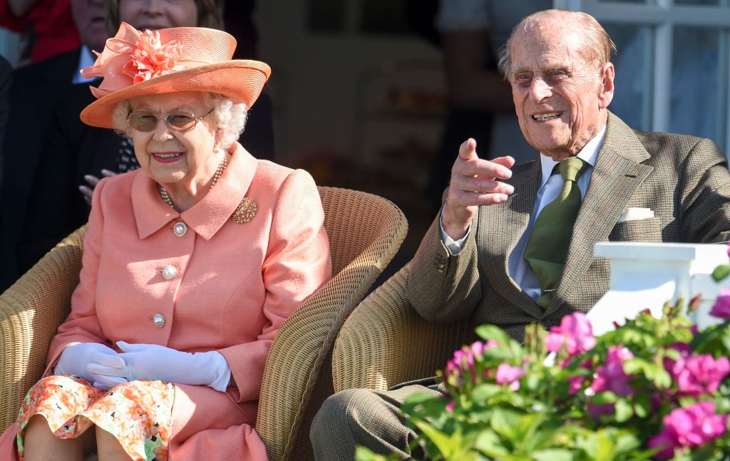 (L) Queen Elizabeth II and (R) Prince Philip watch a polo match