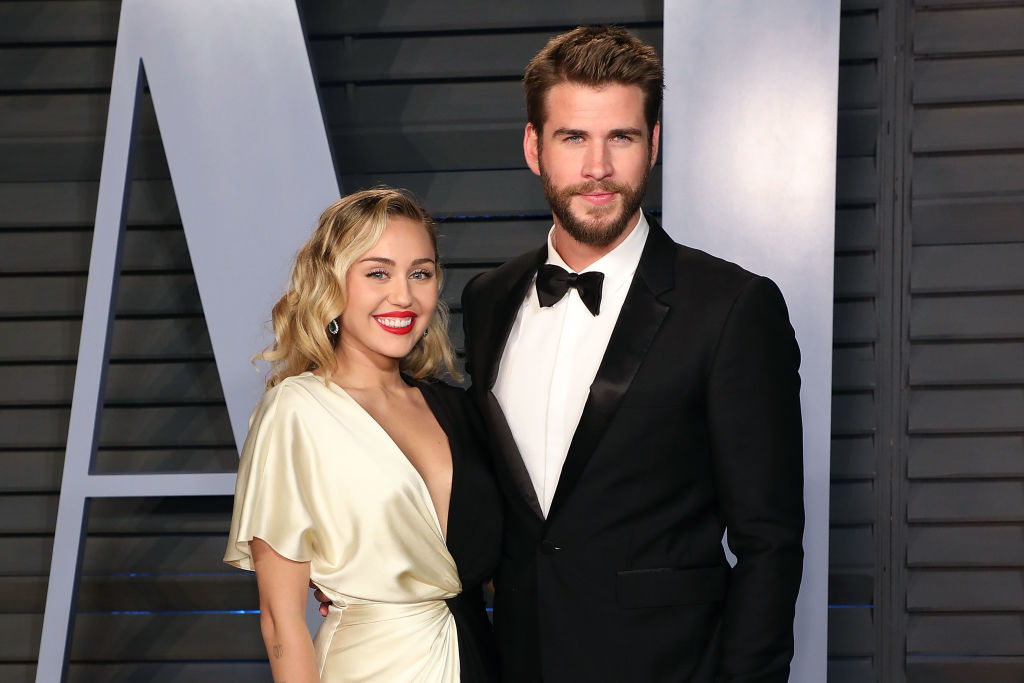 Miley Cyrus and Liam Hemsworth attend a 2018 Vanity Fair Oscar Party.