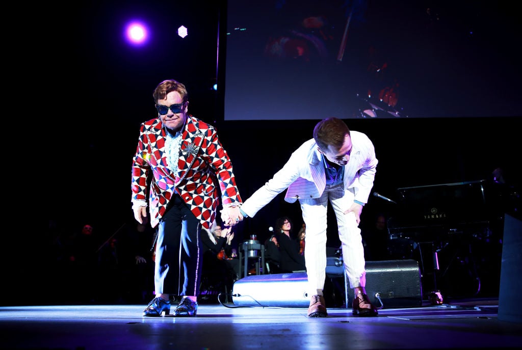 Elton John and Taron Egerton taking a bow after their performance