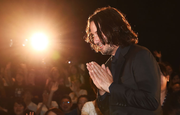 Keanu Reeves greeting crowds onstage