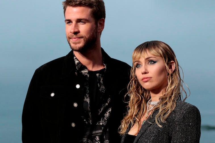 Liam Hemsworth and Miley Cyrus standing together