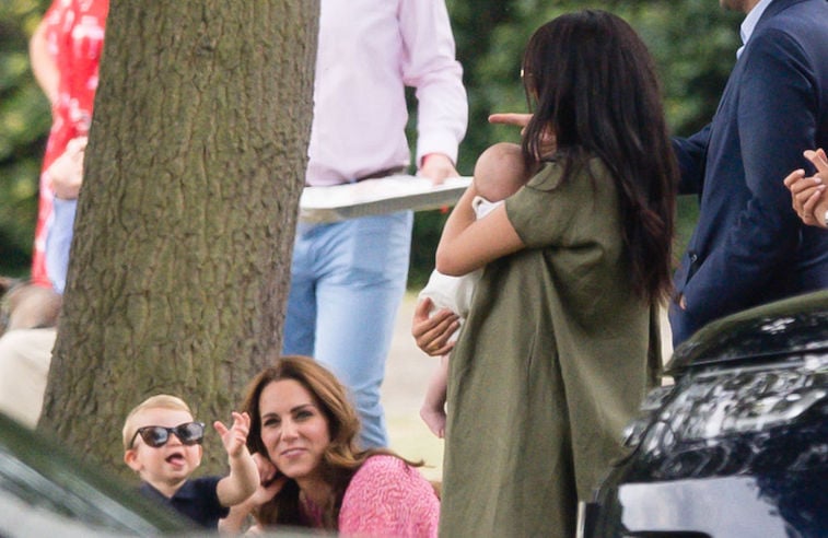 Meghan Markle holds Archie with Kate Middleton and Prince Louis nearby.