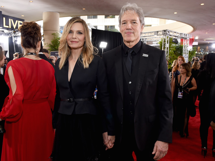 David E. Kelley and Michelle Pfeiffer holding hands at the Golden Globes