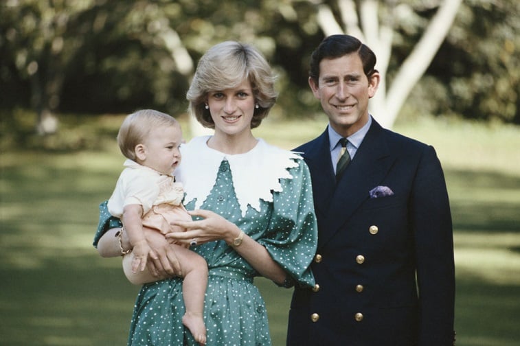 Princess Diana holding Prince William with Prince Charles