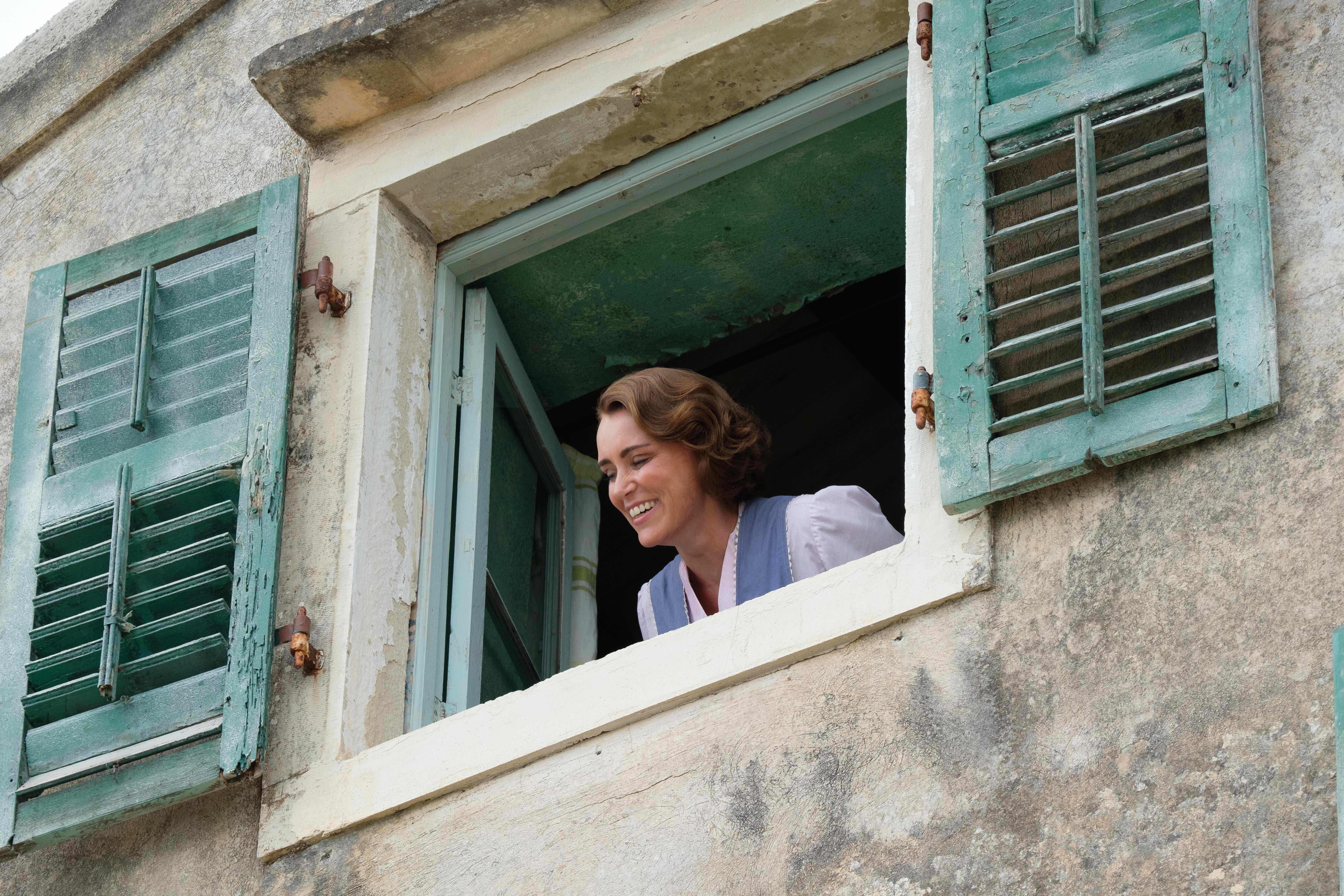 Louisa Durrell looking out window 