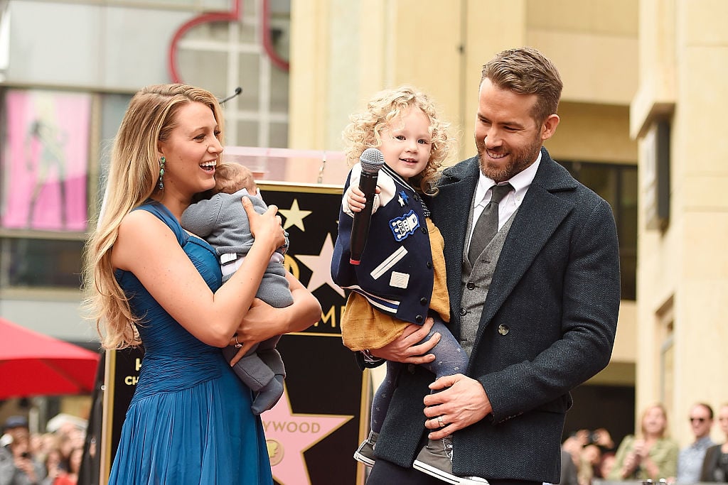 Blake Lively and Ryan Reynolds pose with their daughters on the Hollywood Walk of Fame on December 15, 2016 