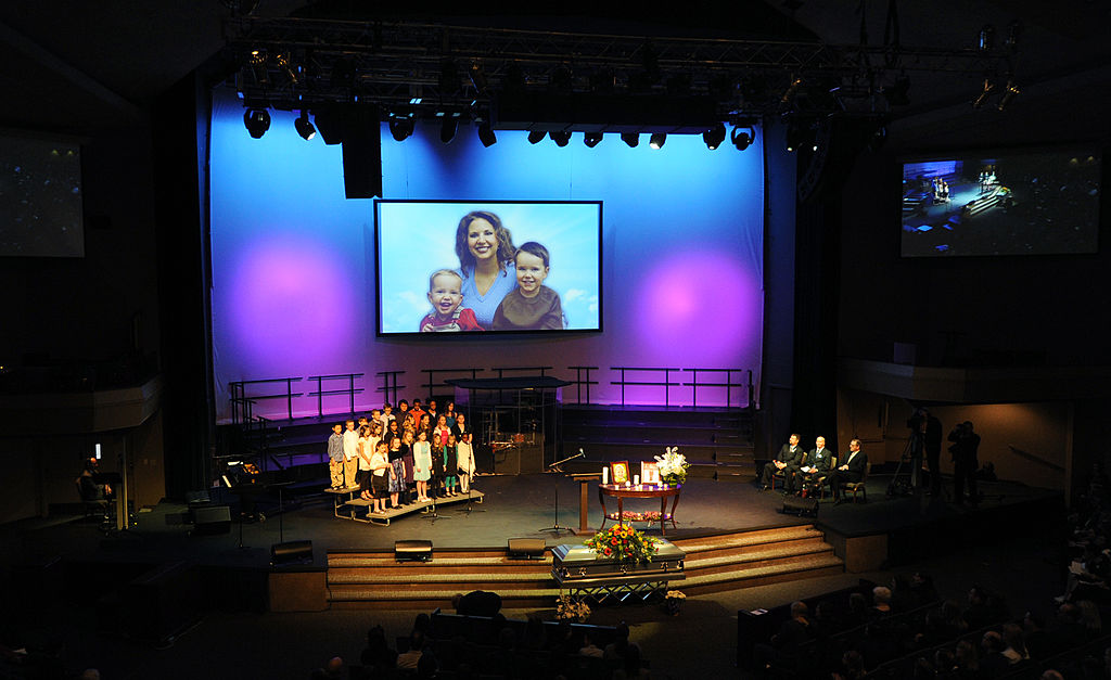 Image of Susan Powell and her children on a large screen