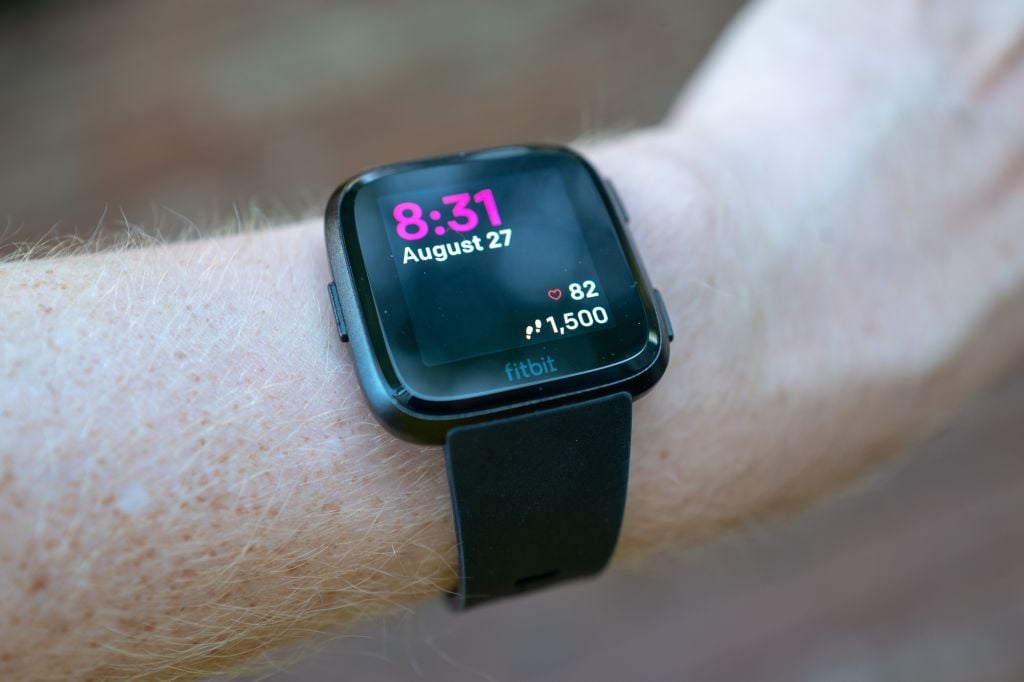 A fitbit on a man's wrist 