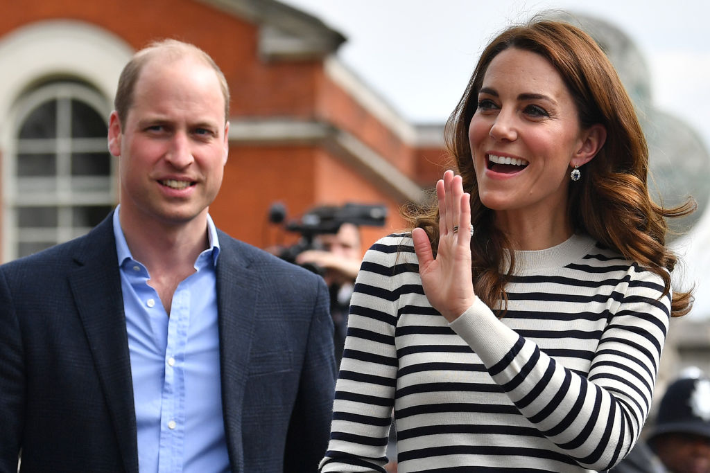 Prince William and Kate Middleton wave to well wishers as they leave after attending the launch of the King's Cup Regatta at Cutty Sark.