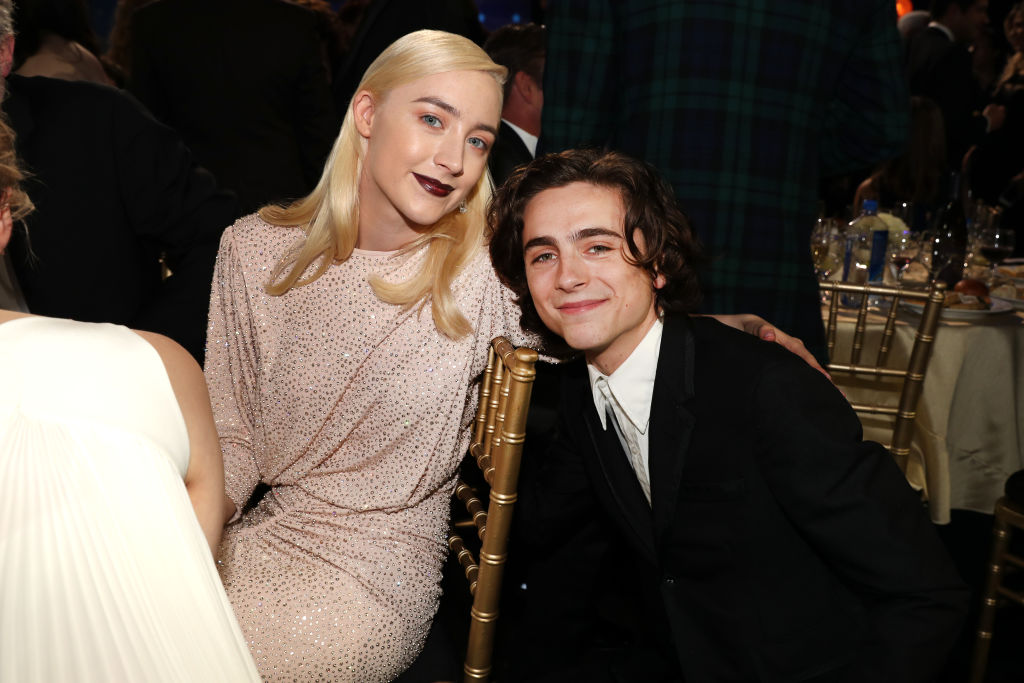 Saoirse Ronan and Timothée Chalamet pose at an award show.