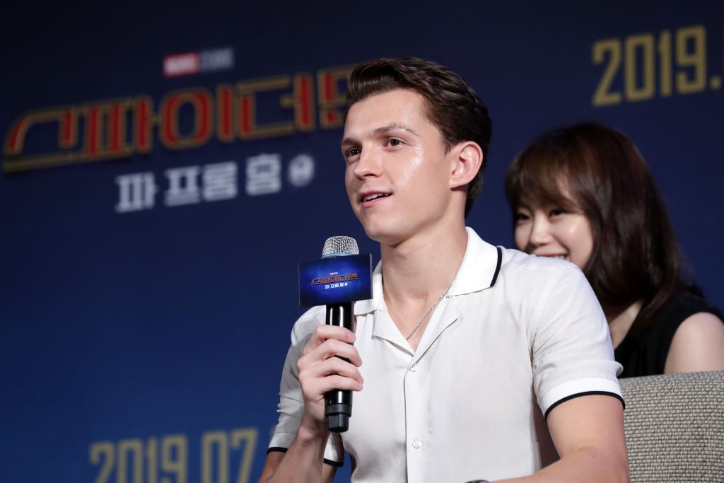 Tom Holland speaking on a panel.