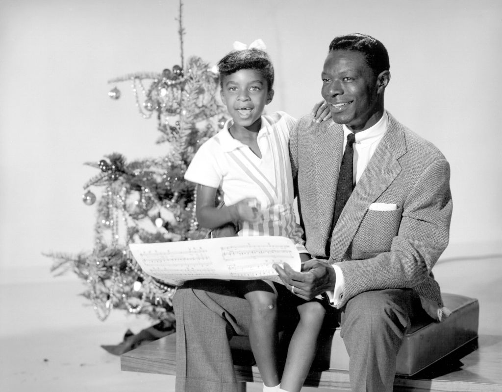 Nat King Cole and his daughter, Natalie Cole, at Christmastime, 1955