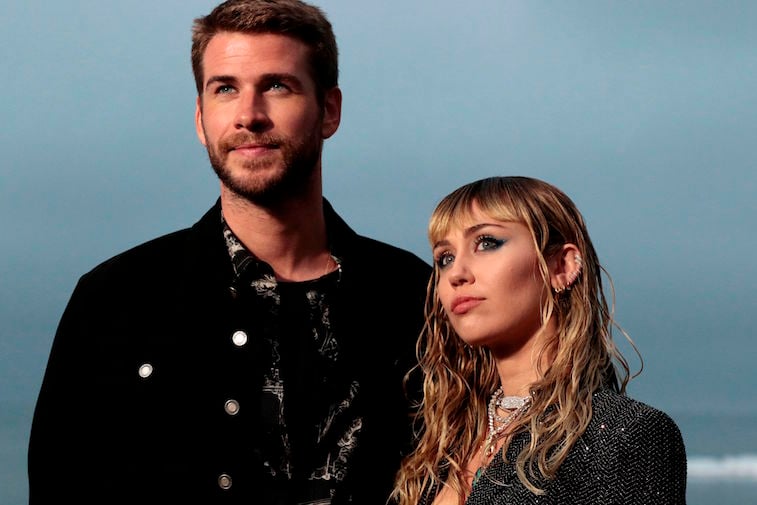 Liam Hemsworth and Miley Cyrus pose for a photo