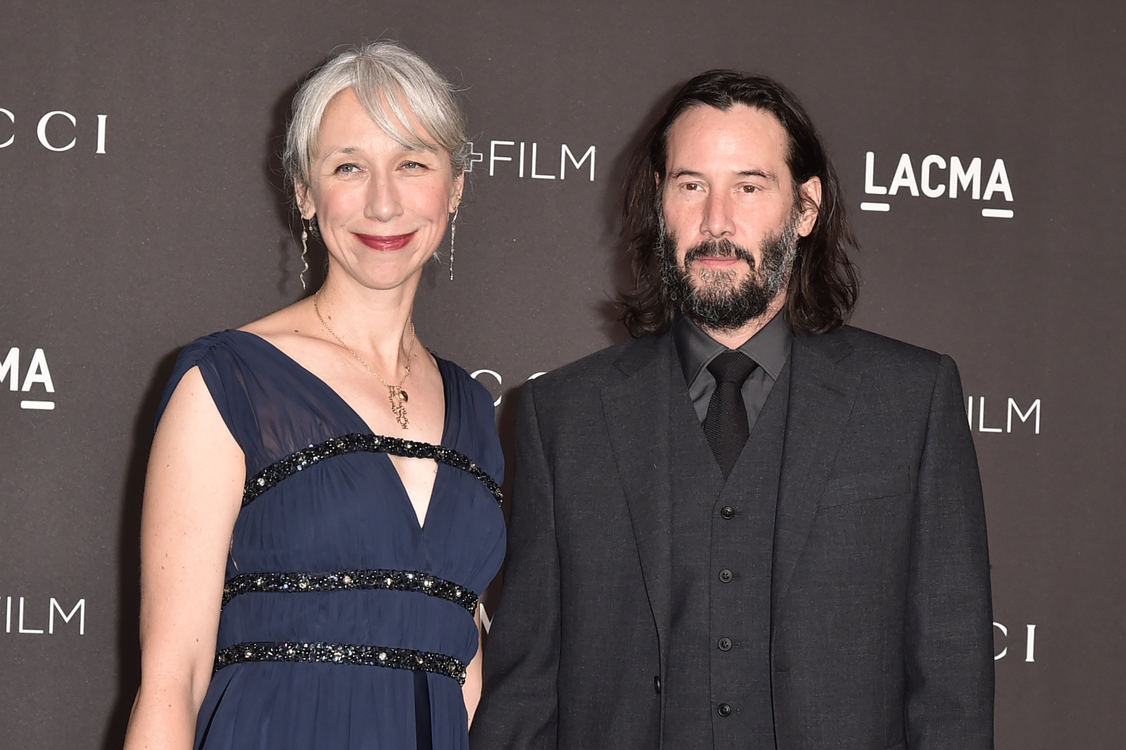 Keanu Reeves and girlfriend Alexandra Grant pose together at an event.