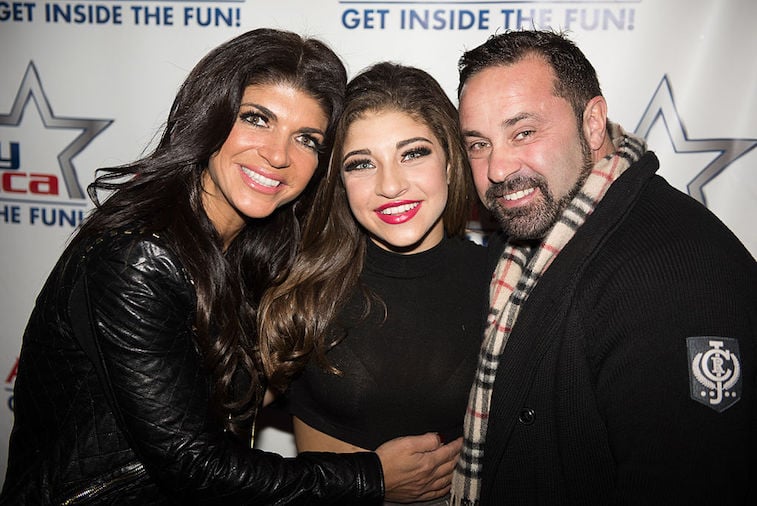 Gia Giudice stands in between her mother and father, Teresa and Joe Giudice