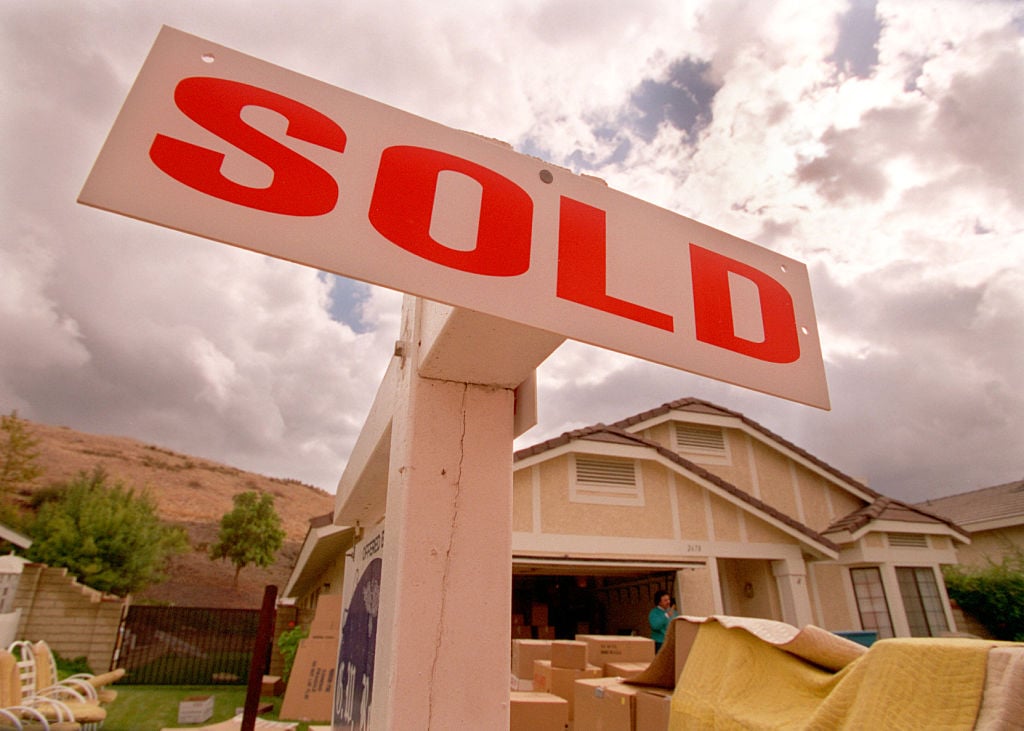 A sold sign in front of a house