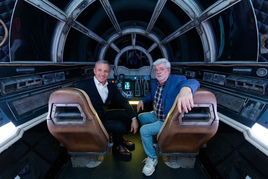 Bob Iger and George Lucas pose inside the Millennium Falcon ride at Disneyland's Galaxy Edge.