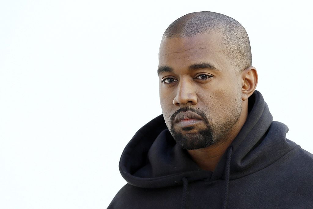 Kanye West poses before Christian Dior 2015-2016 fall/winter ready-to-wear collection fashion show.