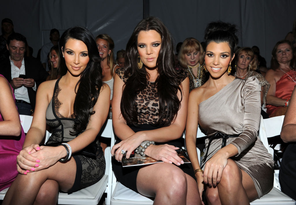Kim Kardashian, Khloe Kardashian and Kourtney Kardashian attend the Beach Bunny Swimwear 2011 fashion show during Mercedes-Benz Fashion Week Swim.