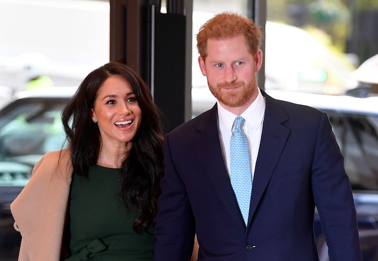 Prince Harry and Meghan Markle smiling at the camera