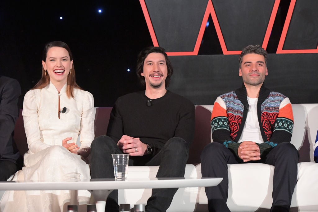 Daisy Ridley, Adam Driver, and Oscar Isaac smile during a press conference for 'The Last Jedi.'