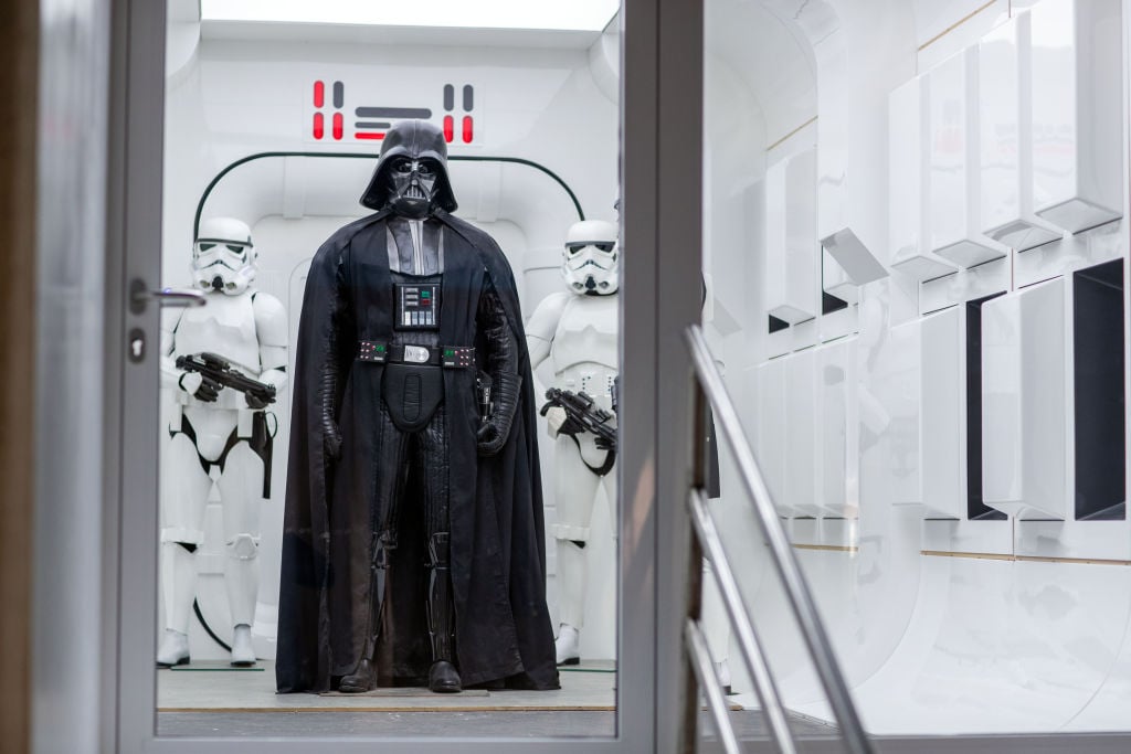 Darth Vader standing with two Stormtroopers. 