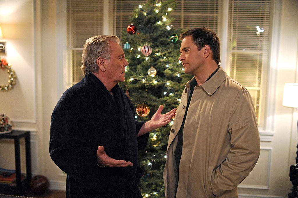 Anthony DiNozzo Sr. and Anthony DiNozzo Jr. speak in front of a Christmas tree in a scene from one of the 'NCIS' Christmas episodes.