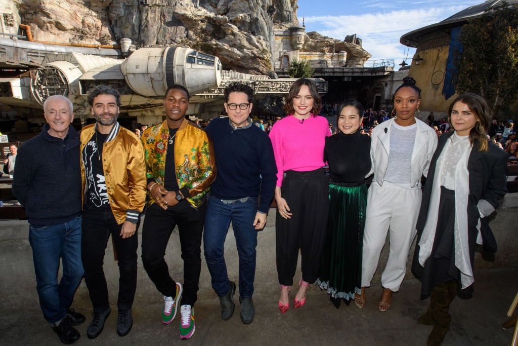 The cast of the upcoming film, Star Wars: The Rise of Skywalker, including Anthony Daniels, Oscar Isaac, John Boyega, director J.J. Abrams, Daisy Ridley, Kelly Marie Tran, Naomi Ackie and Keri Russell in front of the Millennium Falcon in Star Wars: Galaxys Edge at Disneyland Park 